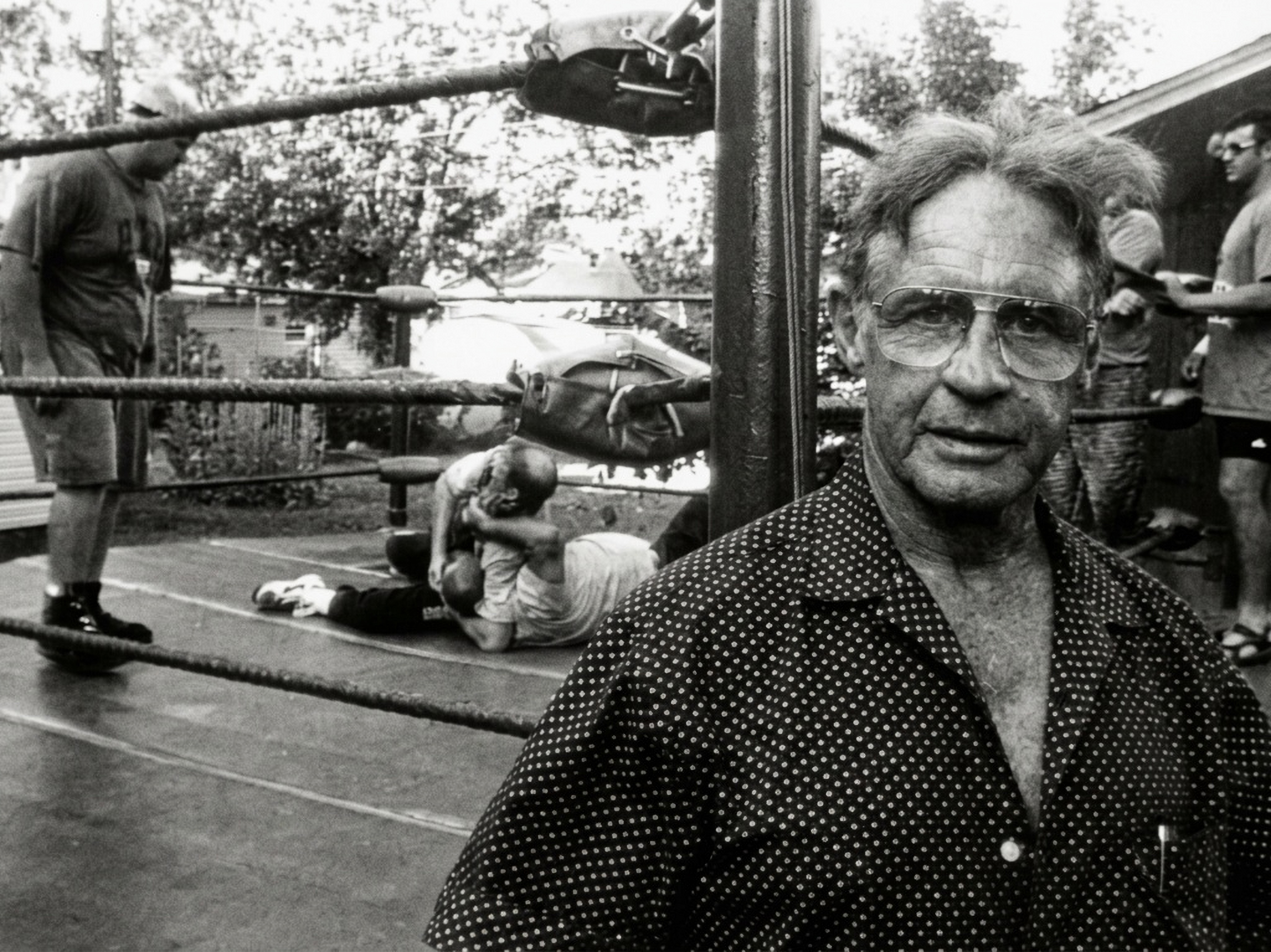 Eddie Sharkey beside the training ring while wrestlers practise