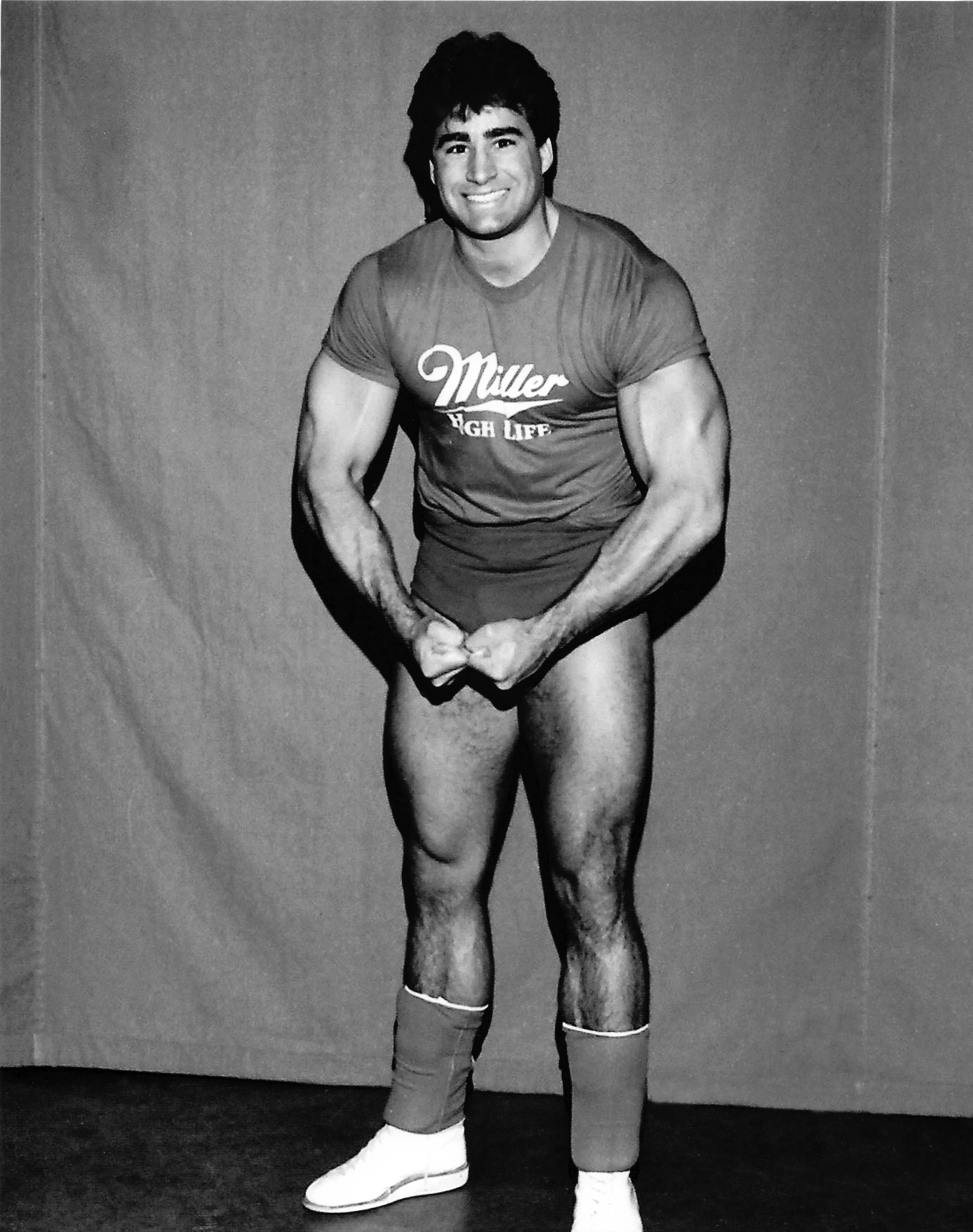 Young Tom Zenk flexing in a promotional photograph